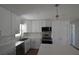 Modern kitchen featuring white cabinets, stainless steel appliances, and elegant countertops at 894 Superior St, Deltona, FL 32725