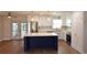 Open kitchen with stainless steel appliances, a blue island, and modern lighting at 894 Superior St, Deltona, FL 32725