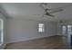 Spacious living room features updated wood floors, fan and large windows at 894 Superior St, Deltona, FL 32725