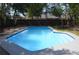 Backyard in-ground pool surrounded by mature trees and a privacy fence at 894 Superior St, Deltona, FL 32725