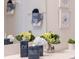Close-up of bathroom quartz countertop with decorative soap dispenser, flowers, and artwork at 926 Balmoral Dr, Davenport, FL 33896