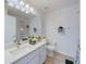 Bright bathroom features a quartz countertop, modern faucet, and decorative light fixture at 926 Balmoral Dr, Davenport, FL 33896