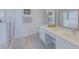 Bright bathroom featuring double sinks, modern cabinetry, and walk-in shower at 926 Balmoral Dr, Davenport, FL 33896