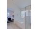 Bathroom showcasing a soaking tub, glass shower, and view of a bedroom at 926 Balmoral Dr, Davenport, FL 33896