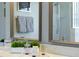 Bathroom vanity featuring double sinks, decorative plants, and a luxurious countertop at 926 Balmoral Dr, Davenport, FL 33896