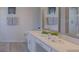 Close up of a remodeled bathroom vanity with granite countertop, mirror and decor at 926 Balmoral Dr, Davenport, FL 33896