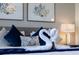 Comfortable bedroom with bed decorated with swan-shaped towels and colorful pillows, with nearby lamp at 926 Balmoral Dr, Davenport, FL 33896