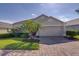 Charming single-story home with well-manicured lawn, lush landscaping, and a two-car garage at 926 Balmoral Dr, Davenport, FL 33896