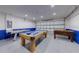 Large game room featuring a pool table, foosball, and air hockey table; garage access nearby at 926 Balmoral Dr, Davenport, FL 33896