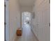 Bright hallway features wood-look floors, fresh white walls and a decorative wicker accent piece at 926 Balmoral Dr, Davenport, FL 33896