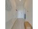 Bright hallway features wood-look floors, fresh white walls and a decorative wicker accent piece at 926 Balmoral Dr, Davenport, FL 33896