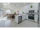 Bright open kitchen with stainless steel appliances and barstool seating at the kitchen island at 926 Balmoral Dr, Davenport, FL 33896