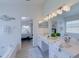 Beautifully remodeled main bathroom with new double vanity, granite countertops, and open doorway to bedroom at 926 Balmoral Dr, Davenport, FL 33896