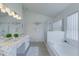 Beautiful main bathroom with large tub, glass enclosed shower, and new double sink vanity with granite countertops at 926 Balmoral Dr, Davenport, FL 33896
