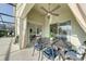 Outdoor patio with stylish seating, ceiling fan, and view of the screened-in pool at 926 Balmoral Dr, Davenport, FL 33896