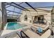 Screened pool with lounge chairs and covered outdoor dining area for relaxing and entertaining at 926 Balmoral Dr, Davenport, FL 33896