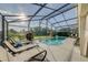 Enjoy this screened-in pool with sun loungers and clear blue water for outdoor relaxation at 926 Balmoral Dr, Davenport, FL 33896