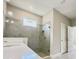 Modern bathroom with glass-enclosed shower and stylish tile work and quartz countertops at 1001 Umbria Dr, Poinciana, FL 34759