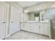 Bright bathroom featuring double vanity with white cabinets and modern fixtures at 1001 Umbria Dr, Poinciana, FL 34759