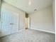 This bedroom features neutral paint, carpet, a walk in closet, and access to the bathroom at 1001 Umbria Dr, Poinciana, FL 34759