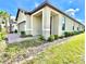 Stunning single-Gathering home showcasing manicured landscaping, side entry, and inviting front porch at 1001 Umbria Dr, Poinciana, FL 34759