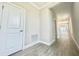 Bright hallway featuring modern flooring, recessed lighting, and access to multiple rooms at 1001 Umbria Dr, Poinciana, FL 34759