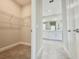 This walk-in closet provides shelving for plenty of storage and the ensuite bathroom at 1001 Umbria Dr, Poinciana, FL 34759