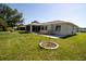 This backyard features a well maintained lawn, a small shade tree, and a screen enclosed porch at 10237 Sw 63Rd Ave, Ocala, FL 34476