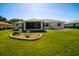 A well maintained lawn, a small shade tree, a screen enclosed porch are the featured elements in the backyard at 10237 Sw 63Rd Ave, Ocala, FL 34476