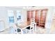Dining room with a wooden table, four chairs, and a beautiful wooden bookshelf at 10237 Sw 63Rd Ave, Ocala, FL 34476