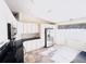 Well-lit kitchen featuring granite countertops, white cabinets, and stainless steel appliances at 10237 Sw 63Rd Ave, Ocala, FL 34476