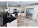 Well-lit kitchen featuring granite countertops, white cabinets, and stainless steel appliances at 10237 Sw 63Rd Ave, Ocala, FL 34476