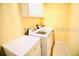 This laundry room has a modern washer and dryer, as well as a storage cabinet at 10237 Sw 63Rd Ave, Ocala, FL 34476