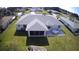 An aerial view of the home's backyard, featuring a screened in porch and patio at 10237 Sw 63Rd Ave, Ocala, FL 34476