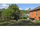 Large backyard with various trees, foliage, and a clothes line at 1107 Dartford Dr, Kissimmee, FL 34758