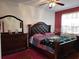 This bedroom offers natural light, with a large bed and matching dresser at 1107 Dartford Dr, Kissimmee, FL 34758