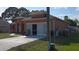 Exterior elevation of a charming home featuring a two-car garage and well-kept lawn at 1107 Dartford Dr, Kissimmee, FL 34758