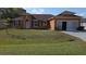 Charming one-story home with a well-maintained lawn and inviting curb appeal at 1107 Dartford Dr, Kissimmee, FL 34758