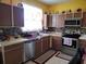 Functional kitchen with stainless steel appliances, tile backsplash, and ample cabinet space at 1107 Dartford Dr, Kissimmee, FL 34758