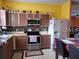 Well-lit kitchen featuring stainless steel appliances, tile floors, and plentiful cabinetry at 1107 Dartford Dr, Kissimmee, FL 34758