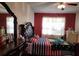 Comfortable main bedroom with a large bed, dresser, and natural light at 1107 Dartford Dr, Kissimmee, FL 34758