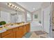 Bathroom with double sinks, tub, and modern lighting fixtures at 1113 Casterton Cir, Davenport, FL 33897