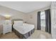 Bright bedroom with hardwood floors, crisp white linens, and natural light at 1113 Casterton Cir, Davenport, FL 33897