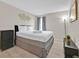 Cozy bedroom with hardwood floors, crisp white linens, and a modern aesthetic at 1113 Casterton Cir, Davenport, FL 33897