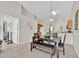 Dining area featuring wood-look floors and modern lighting fixtures. Open concept at 1113 Casterton Cir, Davenport, FL 33897