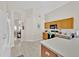 Well-lit kitchen with oak cabinets and stainless steel microwave; open floor plan at 1113 Casterton Cir, Davenport, FL 33897