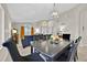 Bright open-concept living and dining area features a dining table, adjacent sofas and ample natural light at 1113 Casterton Cir, Davenport, FL 33897