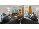 Cozy living room features comfortable seating, a center coffee table, TV, and decorative curtains for a relaxed atmosphere at 1113 Casterton Cir, Davenport, FL 33897