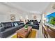 Spacious living area with plush sofas, decorative pillows, a TV on wooden console, and a vibrant area rug at 1113 Casterton Cir, Davenport, FL 33897