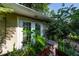 Inviting outdoor view showcasing a cozy patio, lush greenery and privacy at 1209 Marygon St, Kissimmee, FL 34744